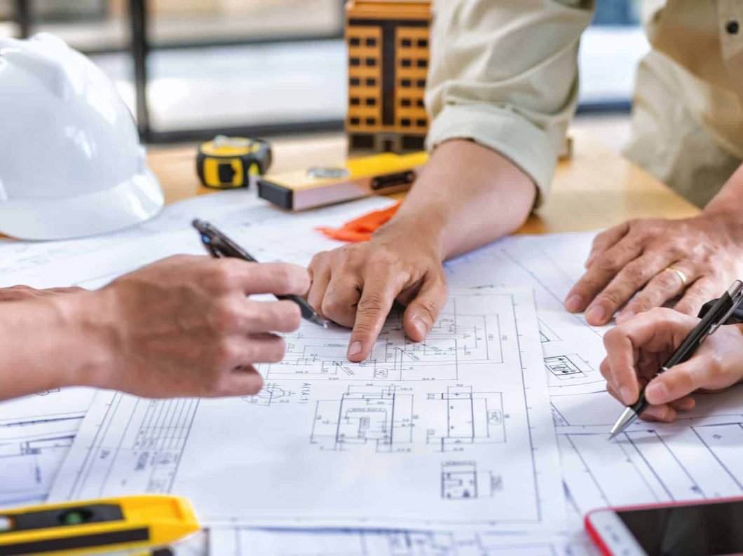 Team-of-construction-contractors-building-out-plans